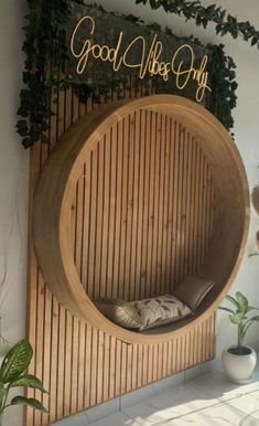 a wooden circular bed with the words good vibes only written in gold on it