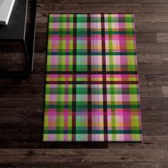 a colorful plaid rug on a wooden floor