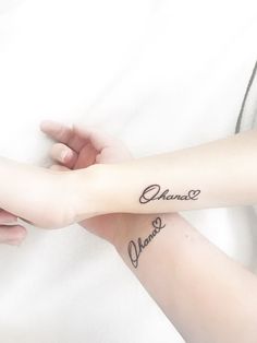 two people holding hands with tattoos on their arms that say chance and chance in cursive writing