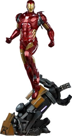 the iron man statue is standing on top of a piece of metal and has his arms outstretched