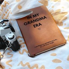 a book with the words in my grandma era on it next to a camera