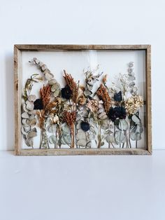 an image of dried flowers in a frame