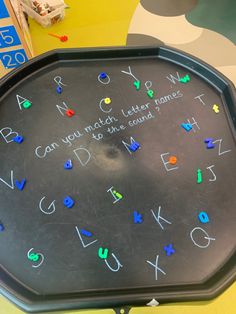 a black tray with letters and numbers written on it