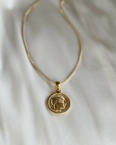 The Greek Goddess Athena Gold Silver Plated Medallion will take you back to a romantic time with it's authentic vintage look and feel. Style Tip: use this as your staple pendant and layer with simple short chains. Choice of 16" or 18" length 18 kt Gold plated Silver Medallion 1" and bail .5" gold filled box chain 1.5 mm thick  20 inches Short Chains Gold, Greek Goddess Athena, Goddess Athena, Athena Goddess, Goddess Necklace, Greek Coins, Gold Coin Necklace, Layer Necklace, Gold Fashion Necklace