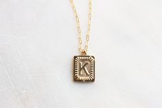 "Trendy and chic this necklace is made for everyday! Wear your favorite letter a rectangle pendant, perfect for a gift too! D E T A I L S -Gold plated rectangle initial pendant -14kt Gold filled shimmering drawn link necklace LENGTH - Please select from the drop down selection. - Choose a 16, 18 or 20 inch inch necklace length. - Standard Length is 18 inches - Pictured at 18\" in photos. C O M P L E T E ∙ T H E ∙ L O O K Styled with: Chunky Link Chain 16\" ∙ EXTRA LOVE ∙ Crafted and curated just Gold Initials Necklace For Everyday, Gold Initials Necklace For Everyday Wear, Everyday Gold Initials Necklace, 14k Gold Filled Initials Necklace For Everyday, Vintage Initial Pendant Charm Necklace As Gift, 14k Gold Filled Initials Charm Necklace For Everyday, Everyday 14k Gold Filled Initials Charm Necklace, Classic Gold Initial Necklace For Gift, Classic Gold Initial Necklace As Gift