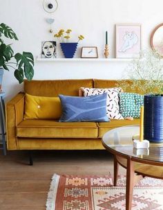 a living room filled with lots of furniture and plants on top of the tables in front of them