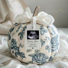 a blue and white pumpkin with a bow on it