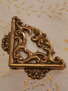 a gold brooch sitting on top of a table