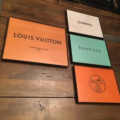 four louis vuitton signs mounted to the side of a wooden wall in a restaurant