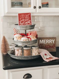 a kitchen counter topped with jars filled with candy and candies on top of a metal tray