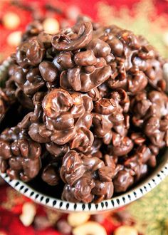 a bowl filled with chocolate covered nuts on top of a table