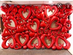 red balloons are arranged in the shape of hearts