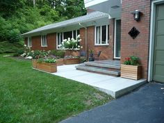 a brick house with flower boxes on the front porch