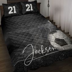 a bed with two pillows on top of it and a soccer ball in the middle