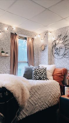 a bedroom decorated in black, white and orange with lights on the wall above the bed