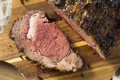 a large piece of meat sitting on top of a wooden cutting board