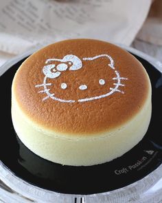 a hello kitty cake on a black plate