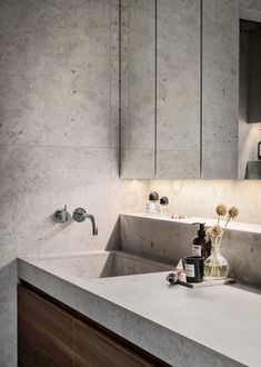 a bathroom with a sink, mirror and soap dispenser on the counter