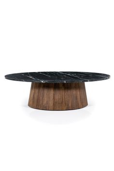 an oval table with black marble top on a wooden base, against a white background