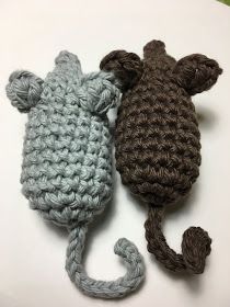 two crocheted mice laying next to each other on top of a white surface