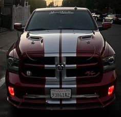 the front end of a red and white striped truck