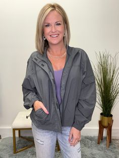 Get ready for cool weather in style with The Perfect Cool Weather Jacket in Gray! This lightweight jacket features a zipper front with Velcro closure, a convenient cargo-style pocket on the sleeve, and an elastic strap to adjust the hem. Stay warm and stylish all season long! Fit: This runs true to size. Stacy is 5’3 wearing a size small. Sporty Windbreaker With Pockets For Travel, Sporty Travel Windbreaker With Pockets, Utility Windbreaker With Pockets For Travel, Fall Windbreaker With Cargo Pockets For Outdoor Activities, Utility Style Windbreaker For Outdoor Activities In Fall, Utility Windbreaker With Long Sleeves For Travel, Utility Long Sleeve Windbreaker For Travel, Fall Utility Windbreaker For Outdoor Activities, Fall Travel Windbreaker With Pockets