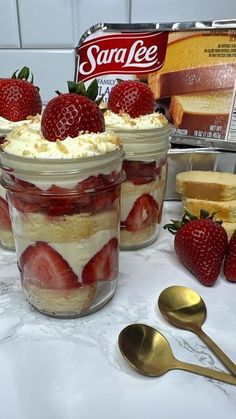 strawberry shortcakes with whipped cream and strawberries in jars