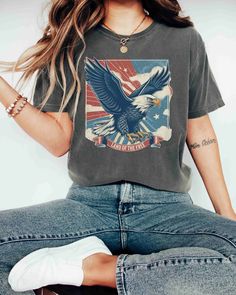 "A Comfort Colors unisex \"USA AMERICAN BALD EAGLE LAND OF THE FREE\" garment-dyed t-shirt made 100% with ring-spun cotton.  USA American Bald Eagle Shirt, Red White and Blue, American Proud Tee, Comfort Colors® Women's 4th of July, Fourth of July T-Shirt, 1776 Tee, America Flag Sweatshirt, USA Sweater, Patriotic Crewneck, 4th Of July Sweater, NYE Shirt, Independence American Flag Tee Retro Flag Tee Gift, Teacher Gift, History Teacher Gift, Love America For an Oversized Look order 1 to 2 sizes l Independence Day Crew Neck Tops Made In Usa, Patriotic Crew Neck Top Made In Usa, American Style Flag Print Top For Veterans Day, American Flag Print Top For Veterans Day, Vintage Crew Neck Tops For 4th Of July, Veterans Day Flag Print Crew Neck Top, American Crew Neck Tops For Independence Day, Americana Crew Neck Tops For Labor Day, Labor Day Crew Neck Top With Flag Print