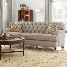 a living room scene with focus on the couch and coffee table in the foreground