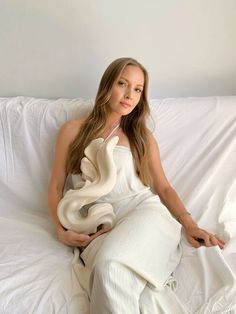 a woman sitting on top of a white couch