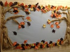 a bulletin board decorated with leaves and branches