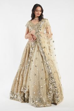 Buy Beige Net V Neck Mirror Embellished Bridal Lehenga Set For Women by Abhinav Mishra Online at Aza Fashions. Festive Gold Pre-draped Saree With Mirror Work, Anarkali Sets With Gold Mirror Work, Gold Anarkali Sets With Mirror Work, Gold Embellished Lehenga For Reception, Traditional Drape Gold Sets With Mirror Work, Traditional Gold Sets With Mirror Work, Designer Gold Lehenga With Sheer Dupatta, Gold Lehenga Saree With Mirror Work, Gold Lehenga With Mirror Work For Reception