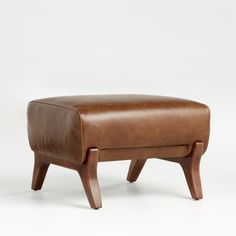 the footstool is made out of wood and leather