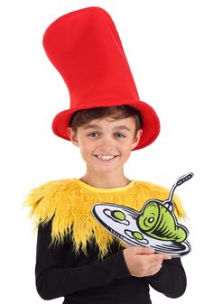 a young boy wearing a dr seuss hat and holding a plate with a worm on it