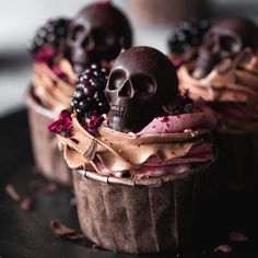 chocolate cupcakes decorated with skulls and berries