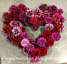 a heart made out of flowers sitting on top of a table