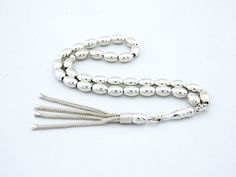 It is made of 100% silver, including the chain. General: 33 pcs 6x9 mm bead size  Weight: 25.2  grams Length: 21 cm including tassel Material:  925 sterling silver. See our other models here: http://www.etsy.com/shop/Tesbih?ref=si_shop   Hand-made. Do not compare it to products sold in the shops. Each one makes the master. Tried using the most robust rope. Disperse a day in two days. Remain intact for many years. Does not Tarnish metals were used. The unique design is unique. Elegant Sterling Silver Rosary In Silver, Elegant Silver Sterling Silver Rosary, Elegant Silver Beads Rosary Gift, Handmade Silver Traditional Rosary, Handmade Traditional Silver Rosary, Traditional Silver Rosary With Polished Beads, Traditional Handmade Silver Rosary, Traditional Silver Rosary As Gift, Islamic Prayer