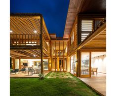 a house that has grass in front of it and some lights on the outside wall