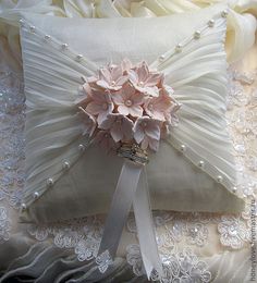 a white pillow with pink flowers on it