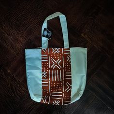 - Lightweight, square shaped tote with African print - one of a kind - 13 1/2 x 13 1/2 x 4 inches - Straps hang 10 inches down Eco-friendly Orange Tote Shoulder Bag, White Hand Printed Bag For Daily Use, White Hand Printed Bag For Everyday Use, White Hand Printed Bags For Daily Use, White Hand Printed Bags For Everyday Use, Hang 10, Orange Pattern, Tote Pattern, Diy Bag