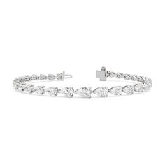 An icon of beauty. This tennis bracelet showcases well-proportioned pear diamonds arranged in graduating sizes, in an exquisite trailing design. The incredibly flattering pear diamonds are laid out in an east-west setting, highlighting the slender and graceful silhouette of each gem. Pear Diamond, East West, Earrings Collection, Tennis Bracelet, Diamond Jewelry, Natural Diamonds, Pear, Jewelry Collection, Tennis