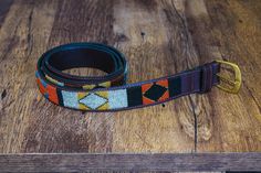 Maasai beaded belt, Leather belt, Handmade belt, African beaded belt, Men belt, Casual belt, Boho belt, Gift for him, Gift for her Handmade in Kenya from 100% Locally Sourced Materials. The belts are beautifully hand-beaded and then hand-stitched on robust but soft cow hide and finished on the inside with a soft goat skin lining The buckles are made using recycled hand casted solid brass. The belt has five holes and the measurement is from the tip of the buckle to the middle hole SIZING Kindly s Adjustable Brown Embroidered Belt, Adjustable Embroidered Brown Belt, Artisan Adjustable Fabric Belt, Adjustable Artisan Multicolor Belt, Traditional Handmade Brown Belt Buckles, Adjustable Artisan Embroidered Belt, Artisan Embroidered Adjustable Belts, Adjustable Beaded Brown Belt, Adjustable Brown Beaded Belt