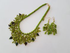 Necklace and earrings of green / mossy glass round and left beads, small green and bronze beads, gift for her, present for women Length of necklace 15.75 inches (40 cm). It can be extended up to 2.36 inches (6 cm) Length of earrings 2.26 inches (6 cm)  Necklace and earrings are ready to ship. By purchasing more from this listing you save postage. You can choose unique handmade gifts for women from my stores https://www.etsy.com/shop/Reriros and https://www.etsy.com/shop/ReriroHandmade It is made Green Czech Glass Necklace With Dangling Beads, Green Czech Glass Jewelry With Dangling Beads, Green Round Beaded Jewelry With Bead Caps, Bohemian Green Necklaces With Matching Earrings, Dark Green Beaded Jewelry Gift, Dark Green Beaded Jewelry For Gift, Bohemian Green Necklace With Matching Earrings, Green Dangle Beads For Gifts, Green Beads With Bead Caps For Jewelry Making