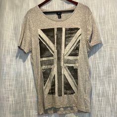 This Cool, Light H&M Cotton-Mix T-Shirt Was An Unused Spare In A Film Shoot. It’s Wholly Unworn, As New. Emblazoned With A Stylized, Monochrome Grey-Scale Version Of The Aunion Jack, The Flag Of Agreat Britain And The Symbol Of Punk, Hooligans, And Ironically Perfect Gentlemen Everywhere. Awesome For Brits, Anglophiles Or Anyone With Exceptional Taste. 5 For $25 - Bundle Any Five $9 Items For $25! Wow!! Silver Graphic Print Top For Summer, Silver Short Sleeve T-shirt For Summer, Casual Silver Tops With Graphic Print, Casual Silver Top With Graphic Print, Summer Silver Top With Graphic Print, Summer Silver Graphic Print Top, Silver Casual T-shirt With Graphic Print, Silver Short Sleeve Graphic Tee, Silver Casual Short Sleeve T-shirt