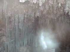 an image of the inside of a window with icicles on it and light coming from behind