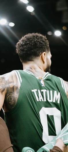 a basketball player with tattoos on his arm