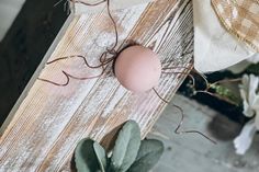 an egg is sitting on top of a piece of wood