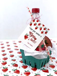 a card in a box with strawberries on it and a stick sticking out of it