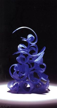 a blue glass sculpture sitting on top of a table