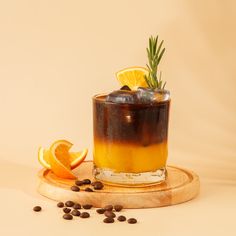 a drink with an orange slice and rosemary garnish